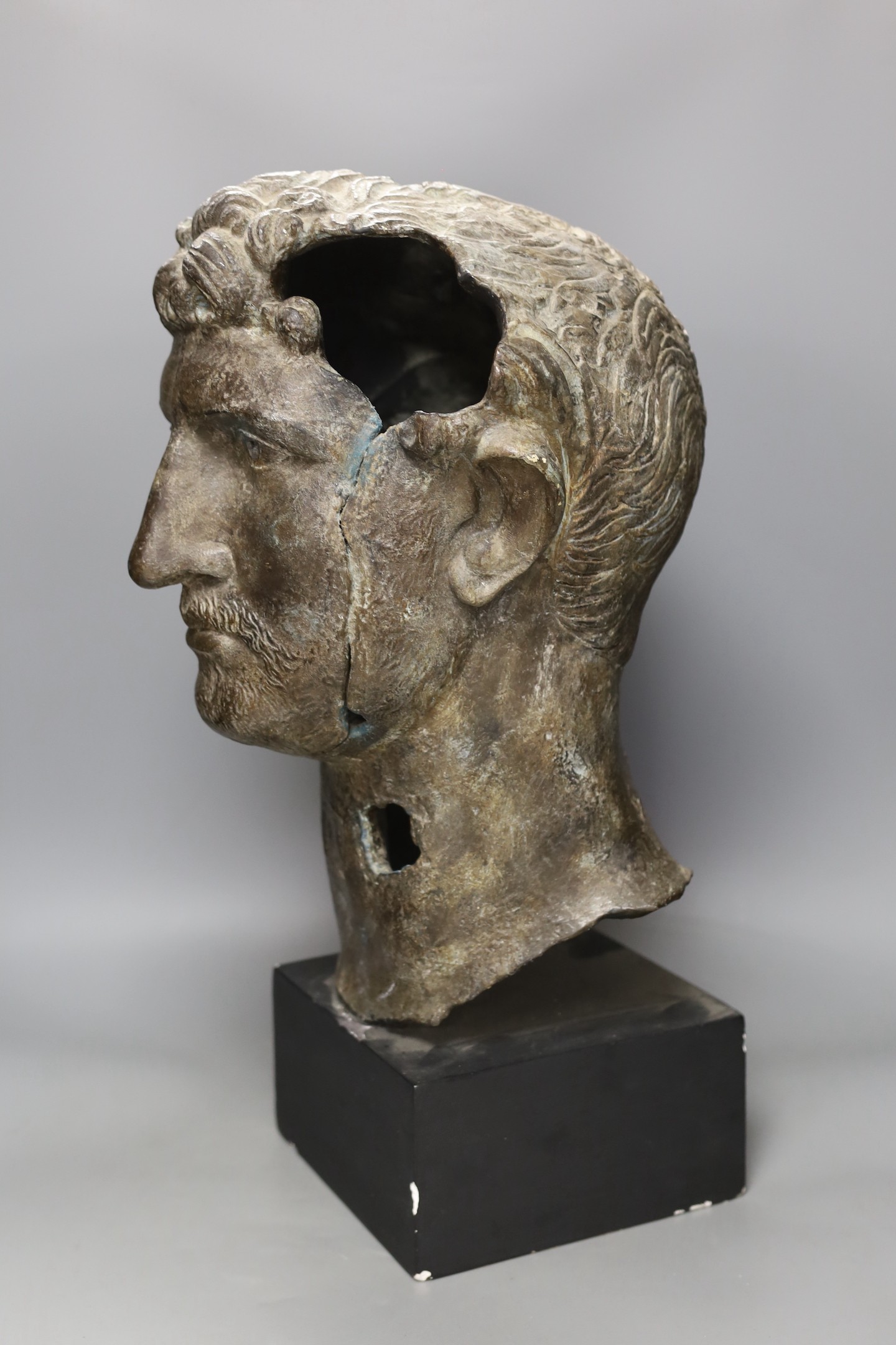 A bronze effect classical bust on stand, 54 cms high.
